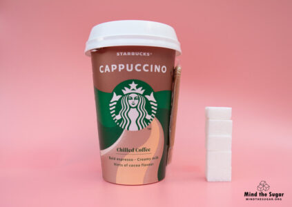 One cup of Starbucks Capuccino contains 18.7g of sugar, equivalent to 4.7 sugar cubes A photo of Starbucks Cappuccino cup with 4.7 cubes of sugar.