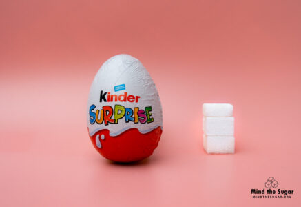One Kinder Surprise Egg contains 10.4g of sugar, equivalent to 2.6 sugar cubes A photo of Kinder Surprise Egg with 2.6 cubes of sugar.