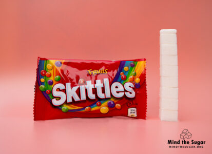 One bag of Skittles Fruit contains 33.2g of sugar, equivalent to 8.3 sugar cubes A photo of Skittles Fruit bag with 8.3 cubes of sugar.